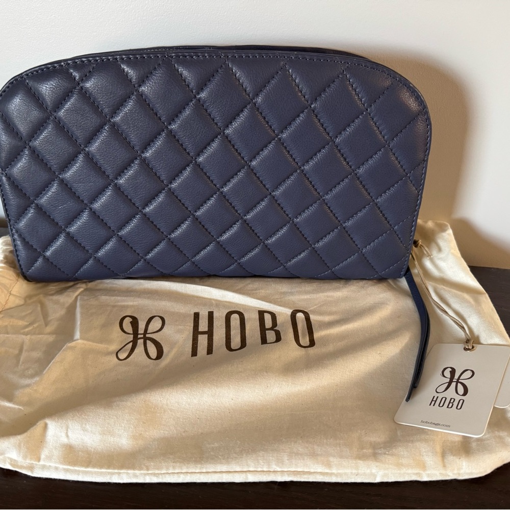 HOBO Quilted Navy Leather Clutch with tan interior, NWT, dust cover included.